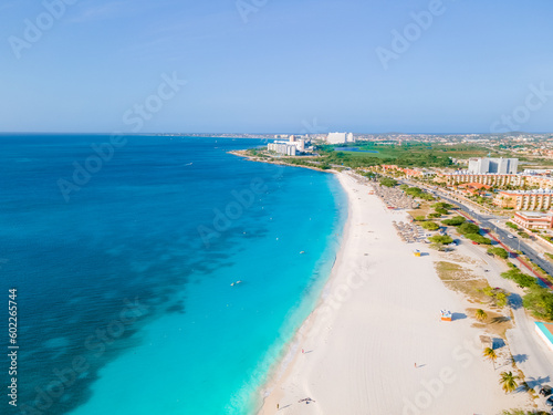 Eagle Beach Aruba, Palm Trees on the shoreline of Eagle Beach in Aruba, an aerial drone view at the beach from above © Chirapriya