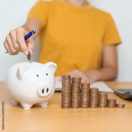 Money Saving for Future Plan, Retirement fund, Pension, Investment, Wealth Business and Financial concepts. hand putting coin into piggy bank, Money Counting and calculate for deposit