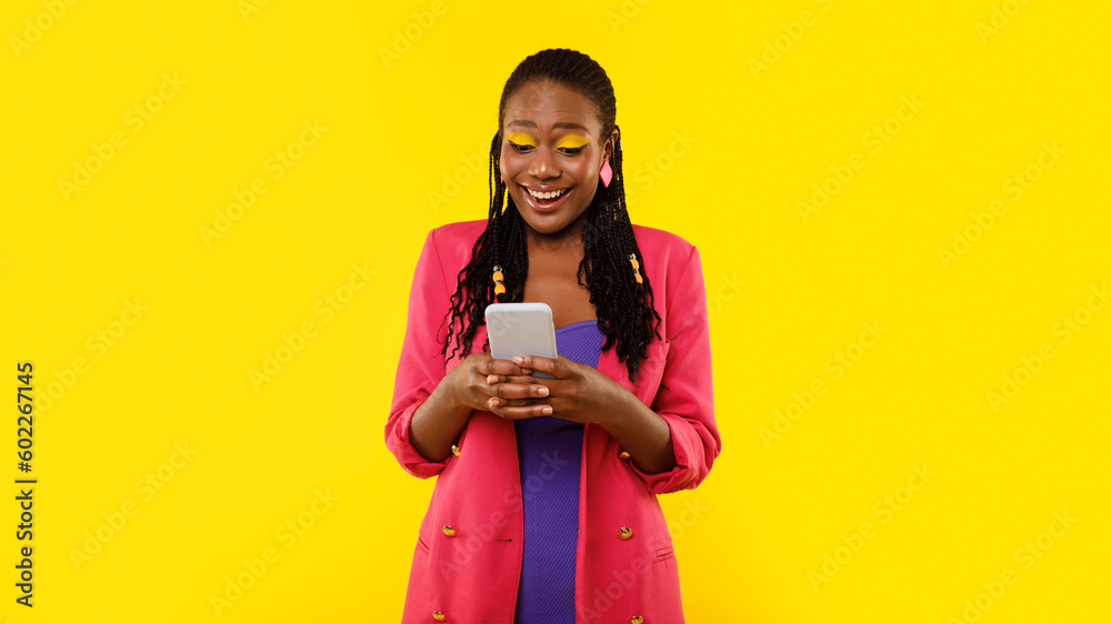 Stylish Black Lady Using Phone Surfing Apps Over Yellow Background Stylish Black Lady Using Phone Surfing Apps Over Yellow Background