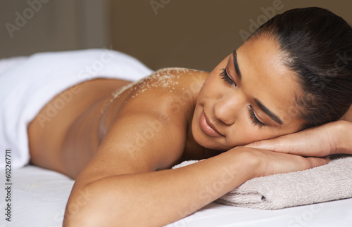 Woman sleeping, body scrub or back massage to relax for zen resting or wellness physical therapy in spa. Eyes closed or girl client in salon to exfoliate for luxury skincare treatment for beauty