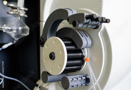 Peristaltic pump with plastic tubes and rollers moving.