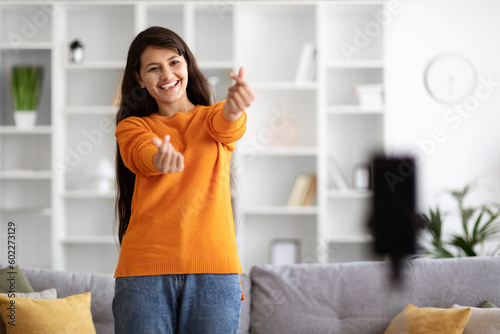 Smartphone recording eastern woman influencer dancing at home