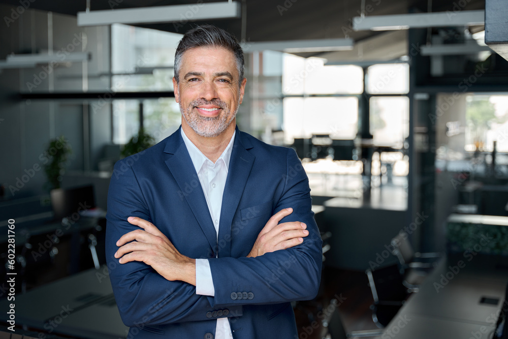 Happy middle aged business man ceo standing in office arms crossed. Smiling mature confident professional executive manager, proud lawyer, confident businessman leader wearing blue suit, portrait. - obrazy, fototapety, plakaty 