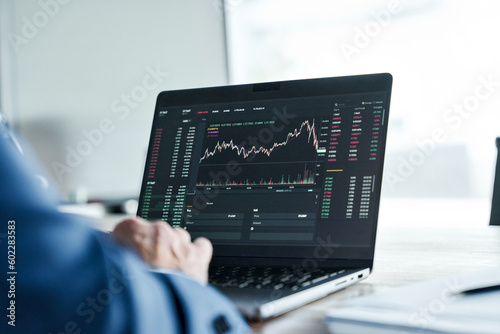 Crypto investor analyst broker analyzing financial stock trade stockmarket exchange platform indexes digital chart data on computer screen thinking of stockmarket invest analytics risk. Over shoulder photo