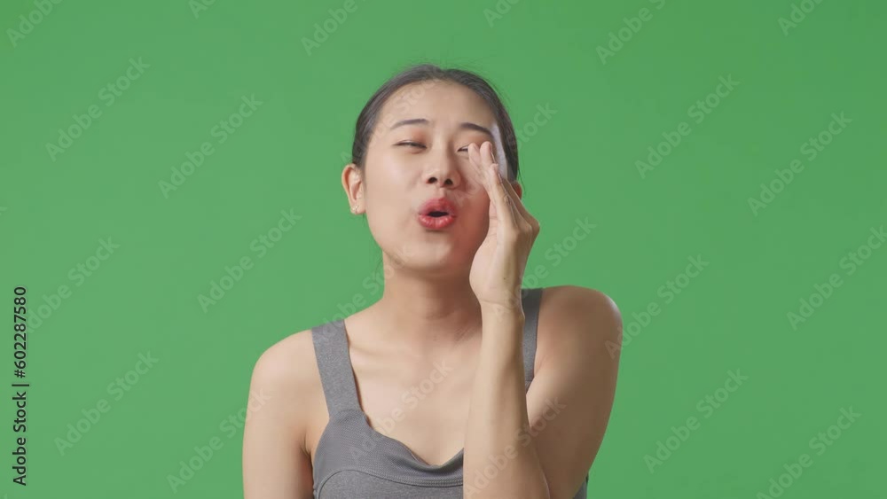 Close Up Of Asian Woman Wearing Sportswear And Yelling Positively With Hand Over Mouth On Green Screen Background In The Studio
Close Up Of Asian Woman Wearing Sportswear And Yelling Positively With Hand Over Mouth On Green Screen Background In The Studio
