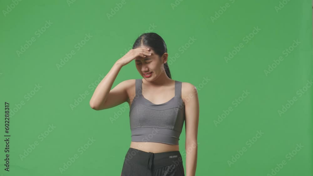Asian Woman Wearing Sportswear And Having A Headache While Standing On The Green Screen Background
Asian Woman Wearing Sportswear And Having A Headache While Standing On The Green Screen Background