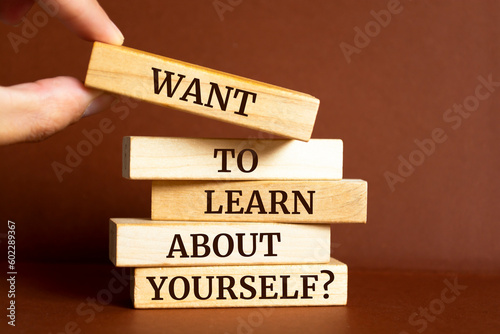 Wooden blocks with words 'Want to Learn About Yourself?'.