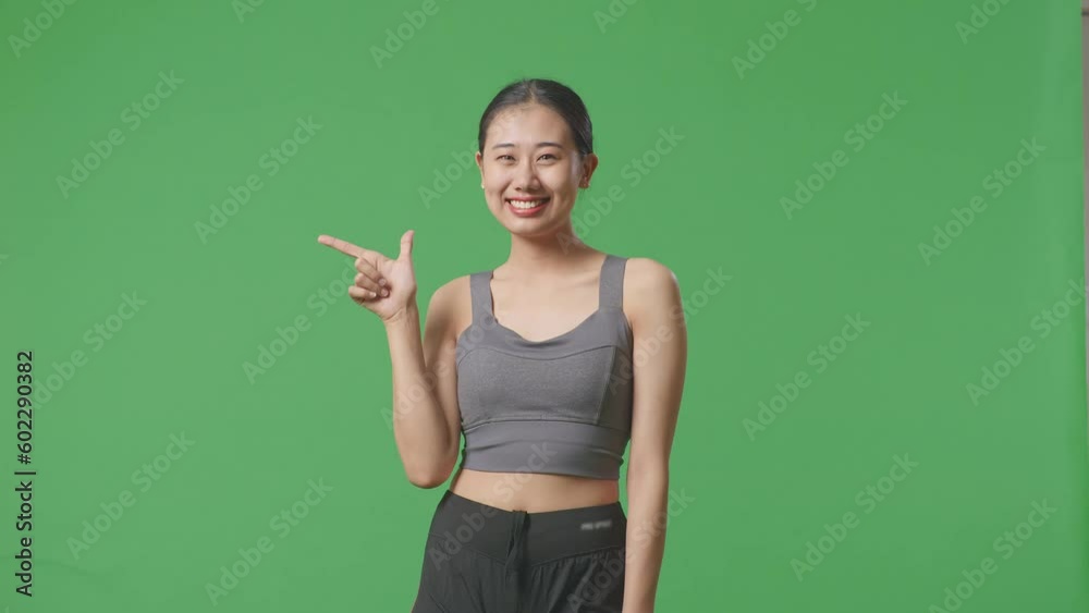 Asian Woman Wearing Sportswear And Smiling, Pointing To Side On Green Screen Background In The Studio
Asian Woman Wearing Sportswear And Smiling, Pointing To Side On Green Screen Background In The Studio