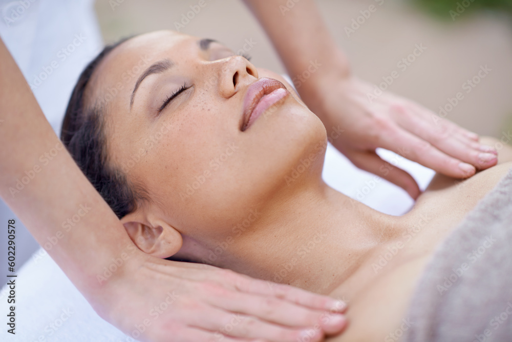 Spa, relax and woman for a massage with therapist hands on body for wellness and health. Face of a calm female client or customer on a table for peace, physical therapy and luxury zen treatment