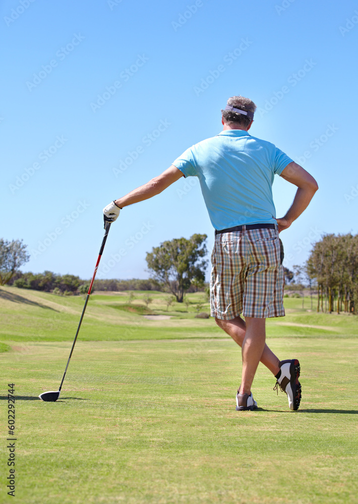 Golf, rear view and old man with driver outdoor for training, hobby and sports on blue sky background. Club, behind and active senior male golfer on field for retirement fitness, match or practice Golf, rear view and old man with driver outdoor for training, hobby and sports on blue sky background. Club, behind and active senior male golfer on field for retirement fitness, match or practice