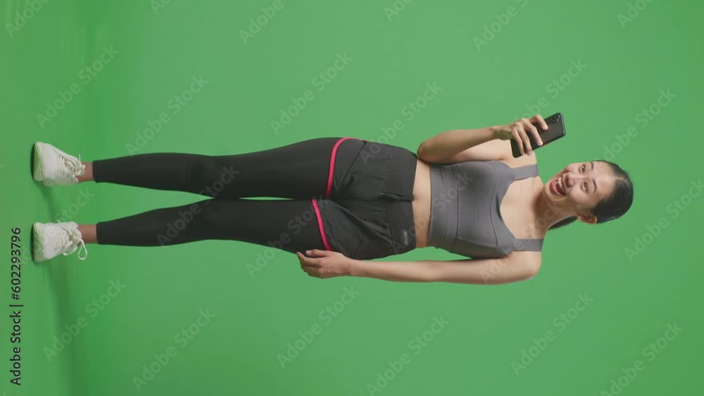 Full Body Of Asian Woman Wearing Sportswear And Looking At Smartphone Then Saying Wow On Green Screen Background In The Studio
Full Body Of Asian Woman Wearing Sportswear And Looking At Smartphone Then Saying Wow On Green Screen Background In The Studio