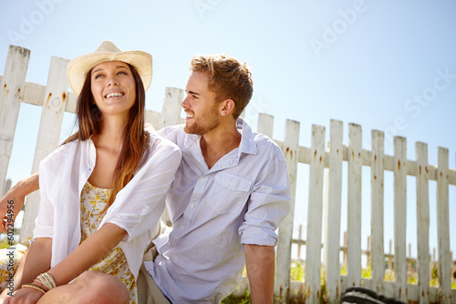 Nature, love and outdoor couple relax, happy and enjoy quality time together on lawn, grass field or picnic mockup. Park fence mock up, sky and people bond on summer holiday in Portugal countryside #602294956
