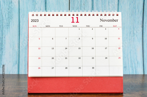 The November 2023 Monthly desk calendar for the organizer to plan 2023 year on wooden table. photo