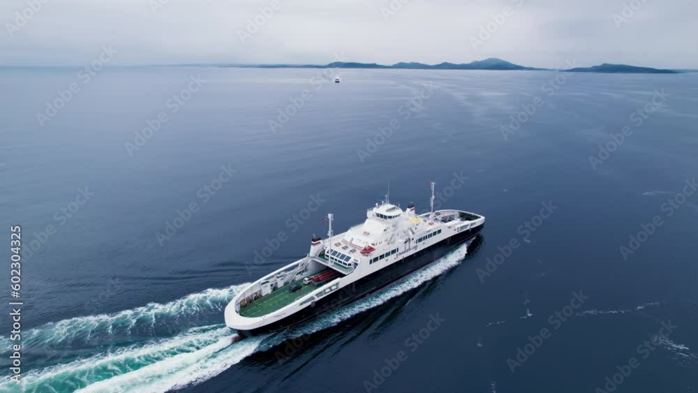 Passenger and vehicle ferry en route between islands or across fjord in open ocean water in Norway. Lounges for passengers and deck for cars and trucks. Marine logistics and transportation 