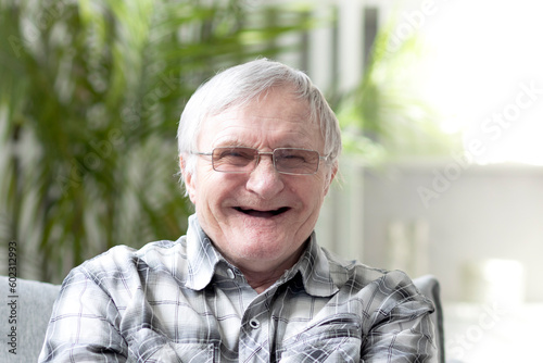 Funny old man without teeth. Portrait of aged pensioner smiling on the camera and demonstrating his positive mood despite of aging process