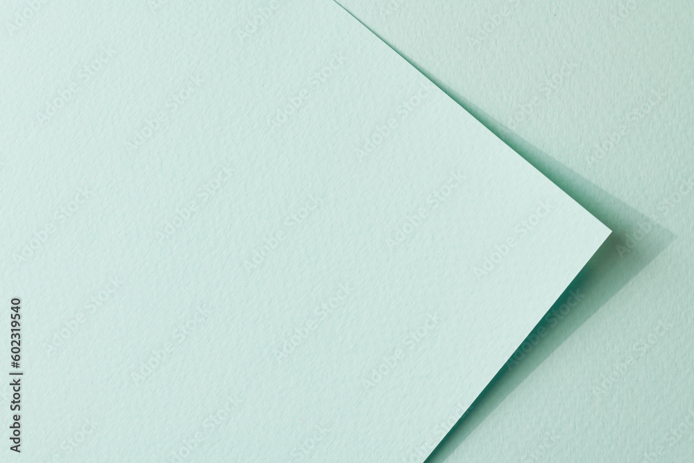 Rough kraft paper pieces background, geometric monochrome paper texture mint color. Mockup with copy space for text Rough kraft paper pieces background, geometric monochrome paper texture mint color. Mockup with copy space for text