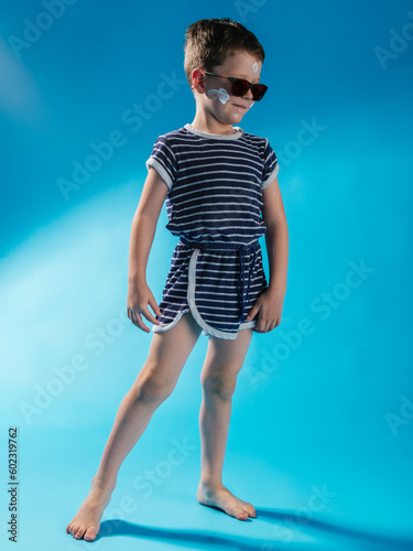 funny boy with sunglasses on blue background