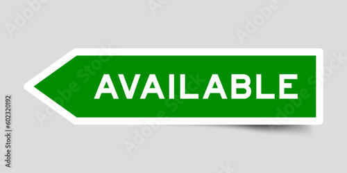 Green color arrow shape sticker label with word available on gray background