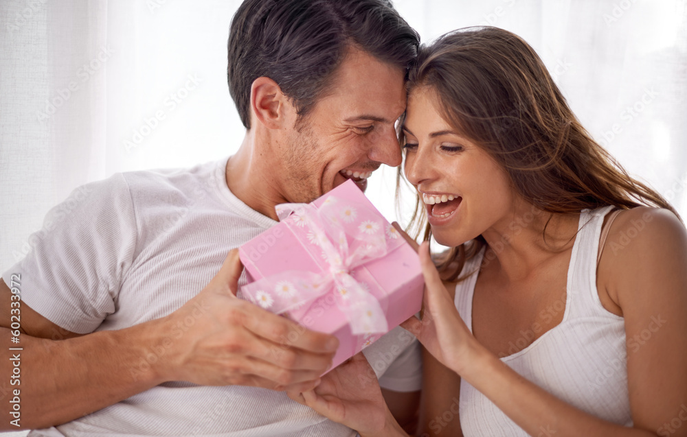 Man giving woman gift, love and happiness with partnership, relationship and celebration on Valentines day date. Couple laugh with present, luxury and commitment, gratitude and celebrate holiday