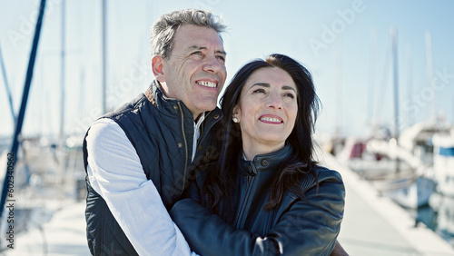 Senior man and woman couple smiling confident hugging each other at port © Krakenimages.com