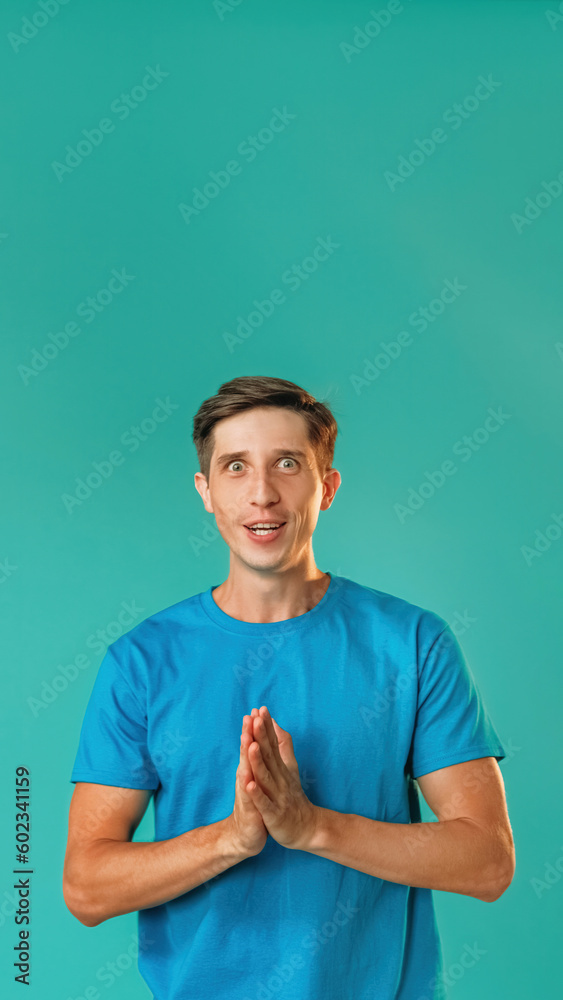 Surprised male portrait. Great achievement. Astonished handsome man in blue looking with amazed excited face isolated on turquoise empty space background.