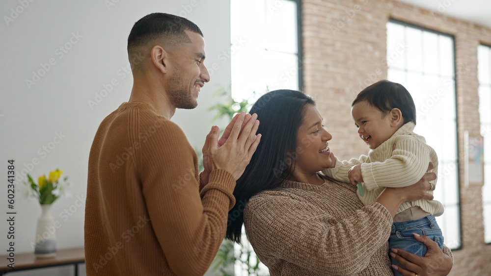 Couple and son hugging each other standing at home Couple and son hugging each other standing at home