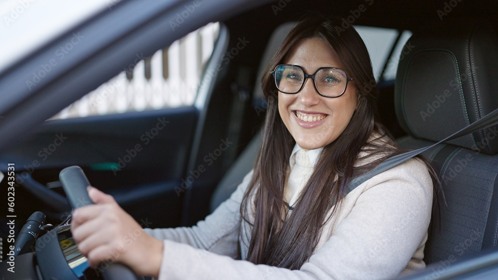 Young beautiful hispanic woman smiling confident driving car at street