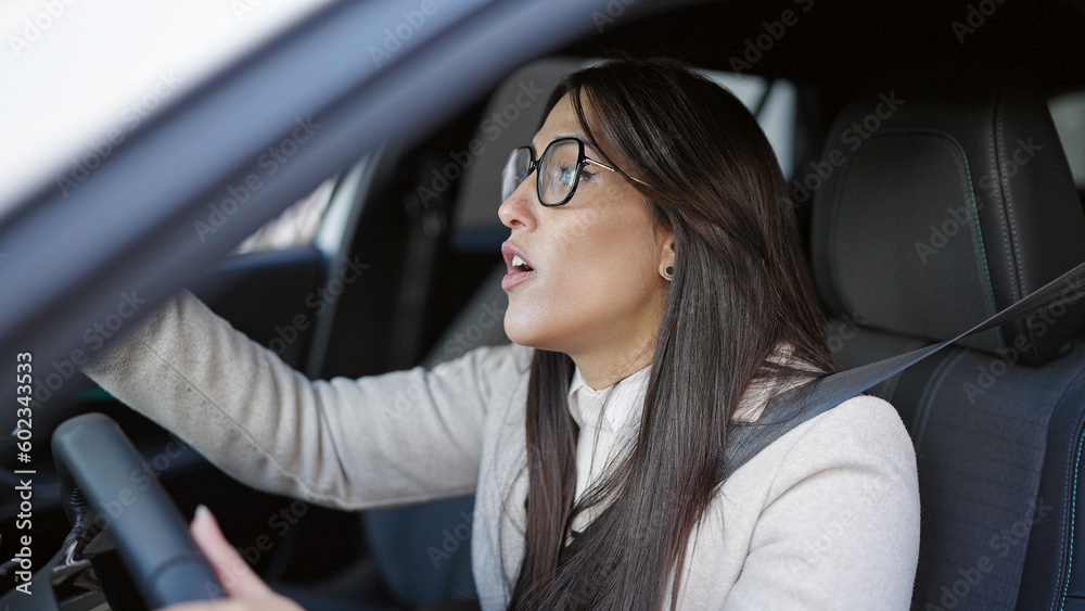 Young beautiful hispanic woman stressed driving car at street Young beautiful hispanic woman stressed driving car at street