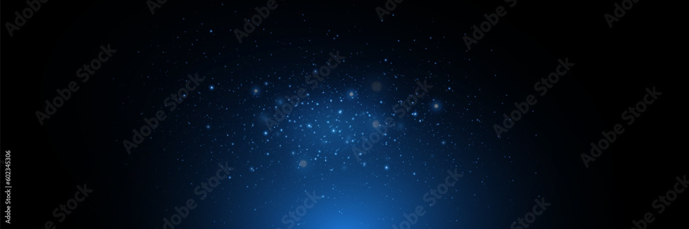 Blue particles of light, shining stars, dust, glitter. On a black background.