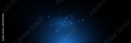 Blue particles of light, shining stars, dust, glitter. On a black background. © DENYS