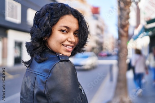 Young latin woman smiling confident standing at street © Krakenimages.com