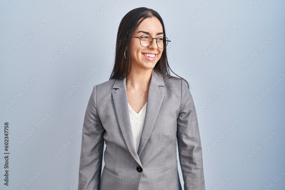 Hispanic business woman wearing glasses looking away to side with smile on face, natural expression. laughing confident. Hispanic business woman wearing glasses looking away to side with smile on face, natural expression. laughing confident.