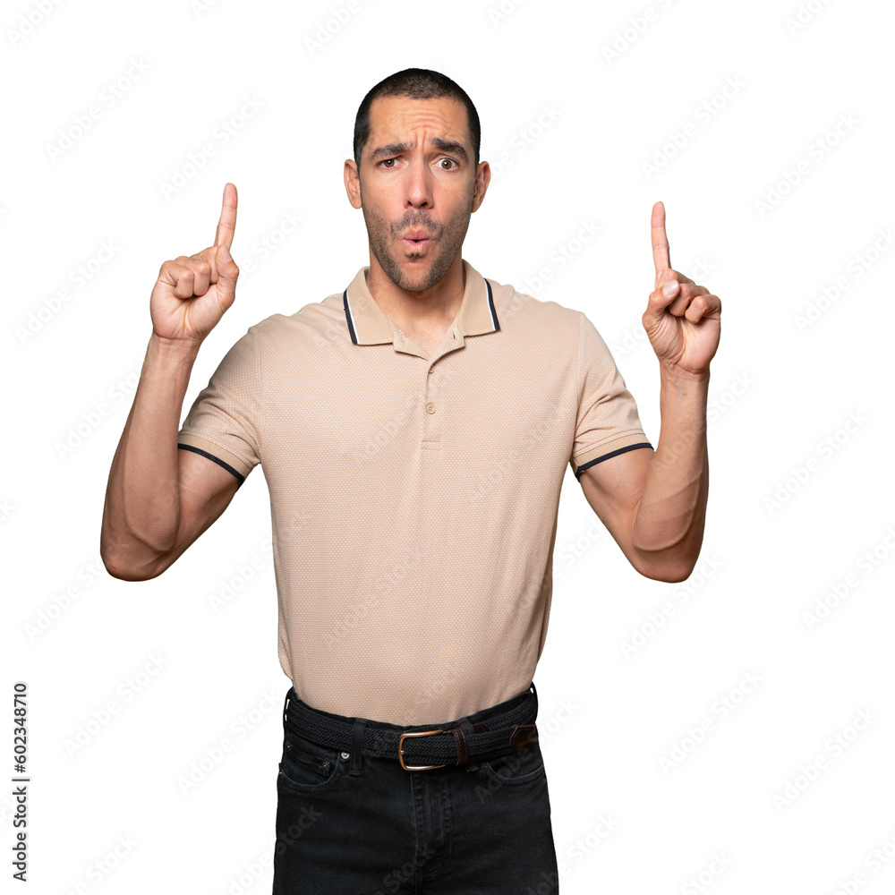 Amazed young man pointing up with his finger Amazed young man pointing up with his finger