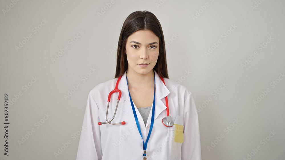 Young beautiful hispanic woman doctor standing with relaxed expression over isolated white background Young beautiful hispanic woman doctor standing with relaxed expression over isolated white background