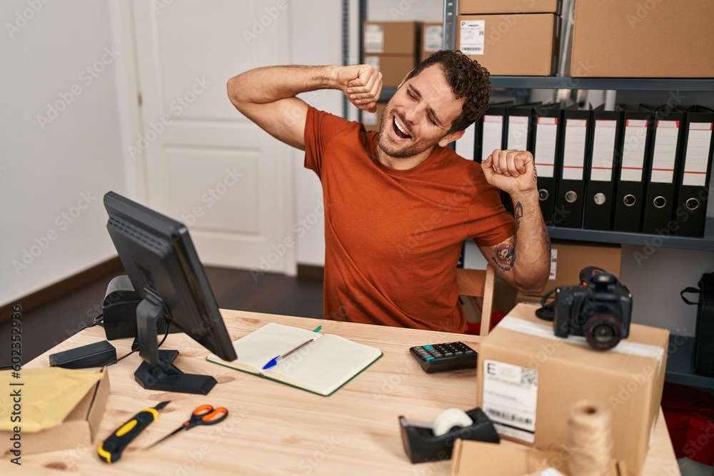 Young hispanic man ecommerce business worker tired working at office Young hispanic man ecommerce business worker tired working at office