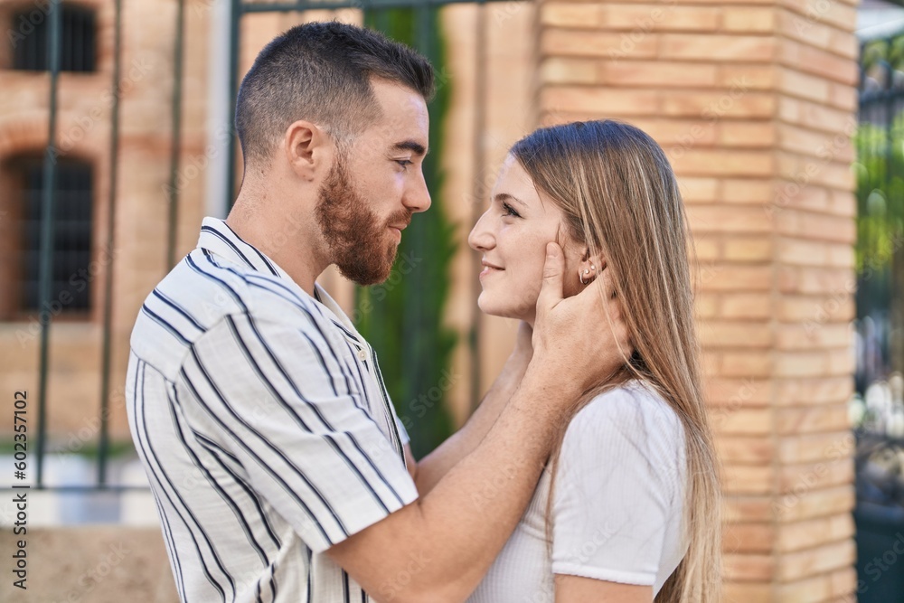 Man and woman couple smiling confident hugging each other at street