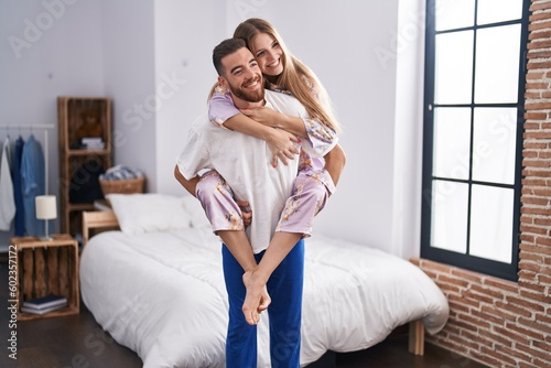 Man and woman couple holding girlfriend on back at bedroom