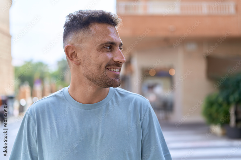 Young hispanic man smiling confident looking to the side at street Young hispanic man smiling confident looking to the side at street