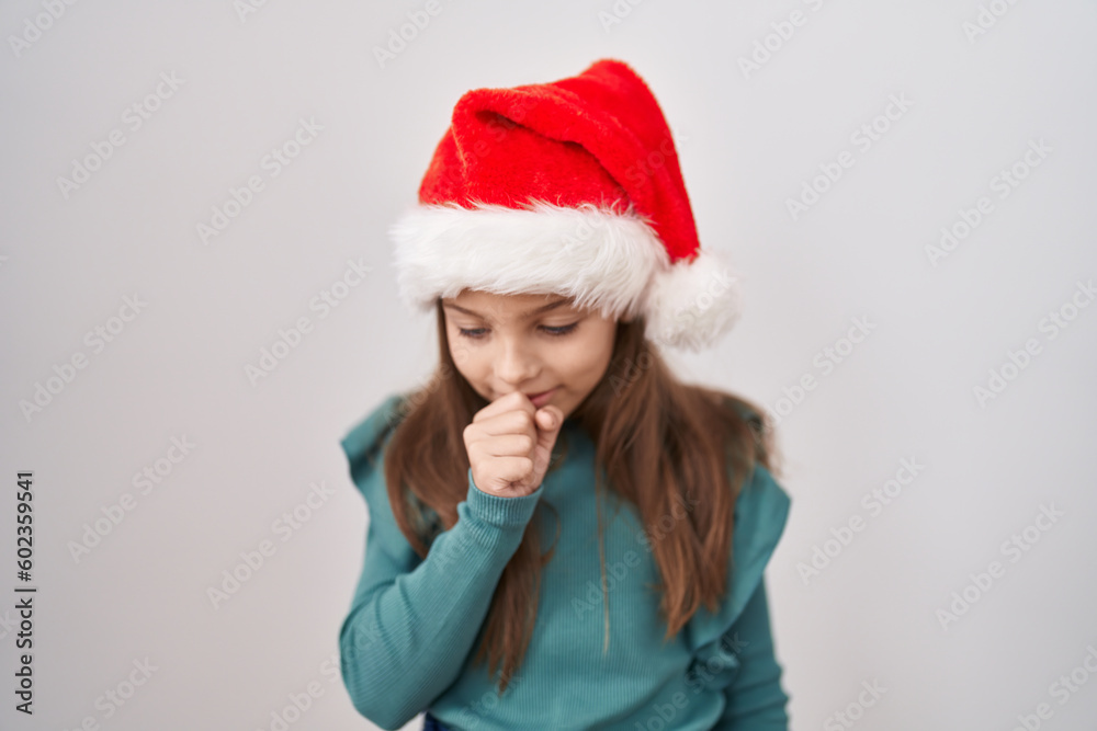 Little caucasian girl wearing christmas hat feeling unwell and coughing as symptom for cold or bronchitis. health care concept. Little caucasian girl wearing christmas hat feeling unwell and coughing as symptom for cold or bronchitis. health care concept.