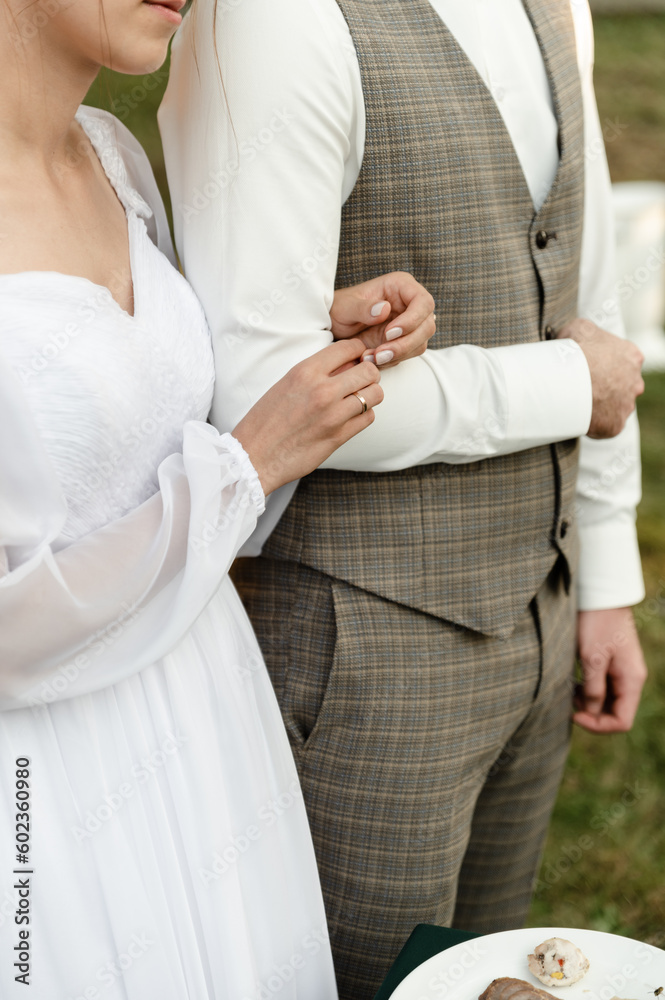 close-up of the hands of the bride hugging the hand of the groom. close-up of the hands of the bride hugging the hand of the groom.