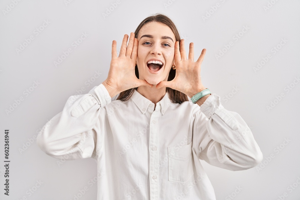 Young caucasian woman standing over isolated background smiling cheerful playing peek a boo with hands showing face. surprised and exited Young caucasian woman standing over isolated background smiling cheerful playing peek a boo with hands showing face. surprised and exited