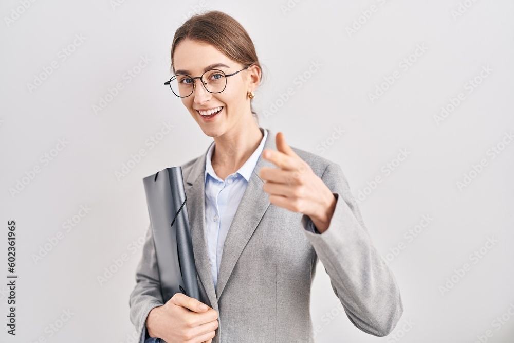 Young caucasian woman wearing business clothes and glasses pointing fingers to camera with happy and funny face. good energy and vibes. Young caucasian woman wearing business clothes and glasses pointing fingers to camera with happy and funny face. good energy and vibes.