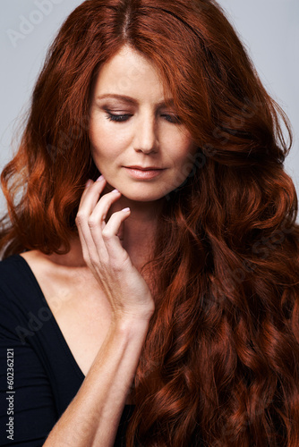Hair care, red head and woman in studio for beauty, wellness and keratin treatment on white background. Haircare salon, hairdresser and ginger female model with shine, healthy and natural hairstyle