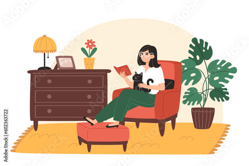 Young woman reading book at home in cozy living room at home