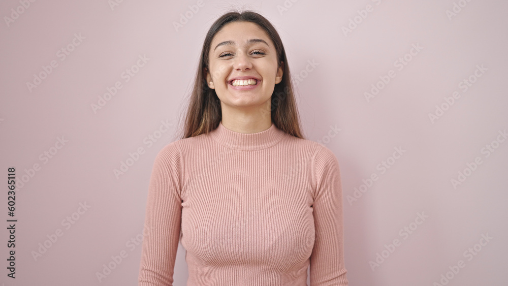 Young beautiful hispanic woman smiling confident standing over isolated pink background