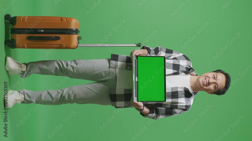 Full Body Of Asian Male Traveler With Luggage Smiling And Showing Green Screen Laptop To The Camera While Standing In The Green Screen Background Studio
Full Body Of Asian Male Traveler With Luggage Smiling And Showing Green Screen Laptop To The Camera While Standing In The Green Screen Background Studio