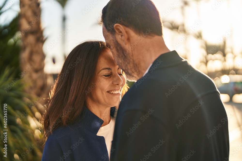 Middle age man and woman couple standing together at park Middle age man and woman couple standing together at park