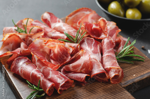 Cured Meat Platter, Coppa with Spices, Italian Antipasto, Appetizer over Dark Background photo