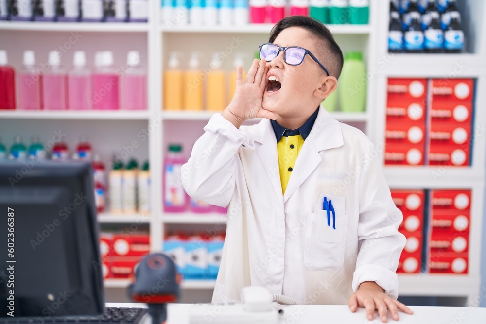 Young hispanic kid working at pharmacy drugstore clueless and confused with open arms, no idea and doubtful face.