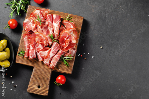 Cured Meat Platter, Coppa with Spices, Italian Antipasto, Appetizer over Dark Background photo